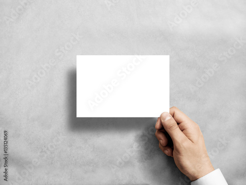 Hand holding blank white postcard flyer mockup. 6 x 4 leaflet mock up presentation. Postal holder. Man show clear post card paper. Sheet template. Invitation booklet reading first person view