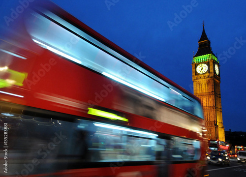 Big Ben and a red double-decker bus at night, London,