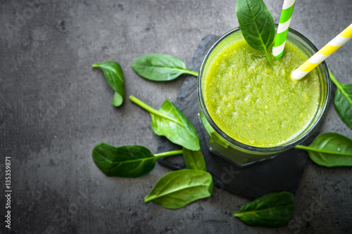 Healthy green spinach smoothie in glass. Clean eating and healthy food.