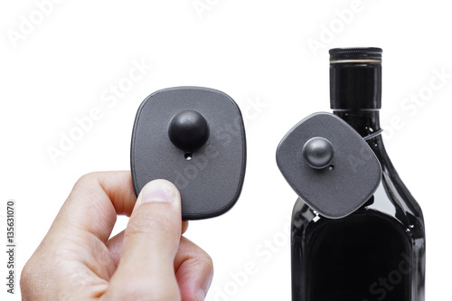 RFID hard tag isolated - Shoplifting and anti-theft system - Electronic Article Surveillance system used with high-value goods - Alcoholic drinks