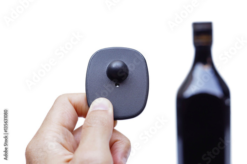 RFID hard tag isolated - Shoplifting and anti-theft system - Electronic Article Surveillance system used with high-value goods - Alcoholic drinks