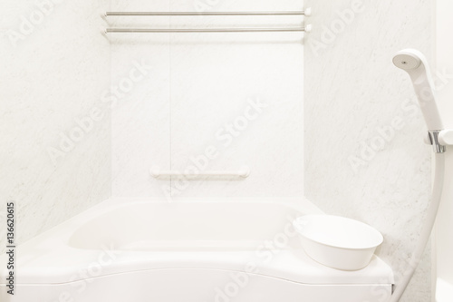 White bathtub and shower at clean bathroom
