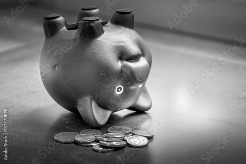Poster Piggy bank upside down on table, financial problems and debt concept