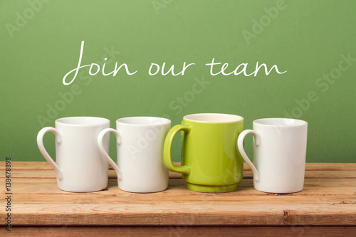 Job recruit concept with coffee cups and text "Join our team". Business background