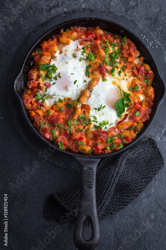 baked eggs with spicy beans and tomato sauce.