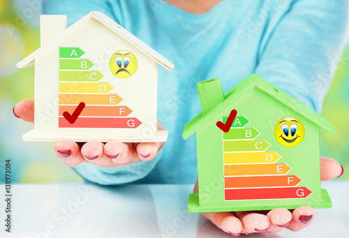 Poster concept comparison between normal house and low consumption house with energy ef