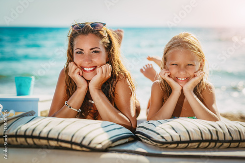 Mom And Daughter Posing At The Beach