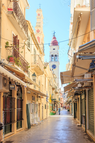  KERKYRA, CORFU, GREECE - Mart 4 2017: Tourists walking and shopping on narrow streets in the historical Kerkyra city center in Corfu near the Cathedral of St. Spyridon of Trimythous
