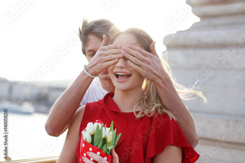 Surprised woman get bouquet from man on first date © sakkmesterke