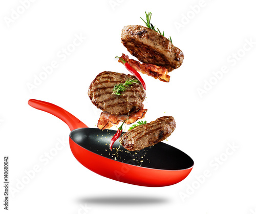 Beef milled meat flying from a pan on white background