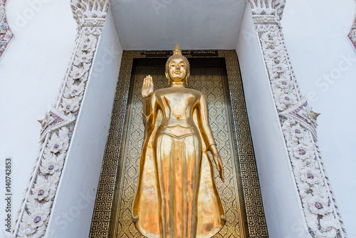 Poster Ayutthaya, Thailand - March, 11, 2017 : Standing golden buddha statue in front of the church at Wat cheing len temple Thailand