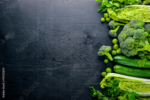 Poster Collection of fresh green vegetables placed on black stone
