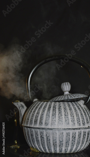 the kettle on the stove on a black background