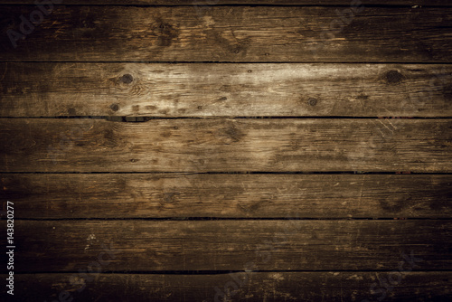 Fototapeta Old rural wooden wall in dark brown and black colors, detailed plank photo texture. Natural wooden building structure background.