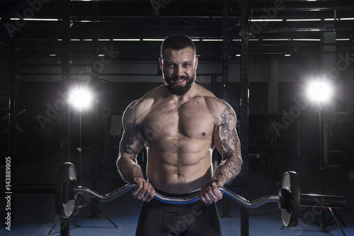 Poster Muscular Man Doing Heavy Weight Exercise For Biceps With Barbel