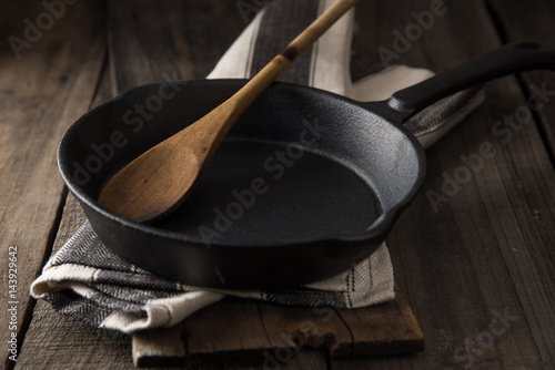 Cast iron frying pan on country rustic wooden/timber background