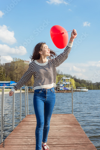 Poster Portrait pretty happy smiling woman with air balloons heart shaped park outdoor