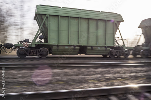 Poster Panning a freight train on the railway in the spring evening, at sunset