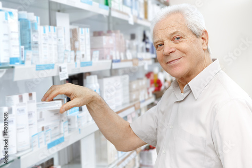 Senior male customer choosing products at the store