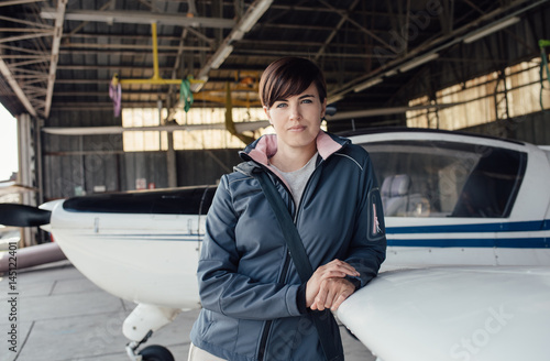 Female pilot posing in the hangar