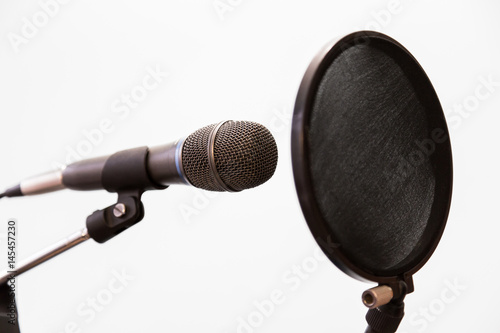 Poster Cardioid condenser microphone and pop filter on a gray background