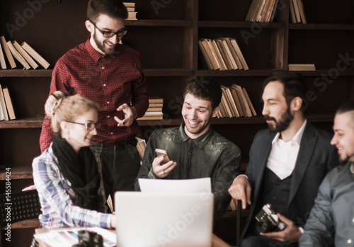 Poster friendly team of copywriters in the workplace in modern office