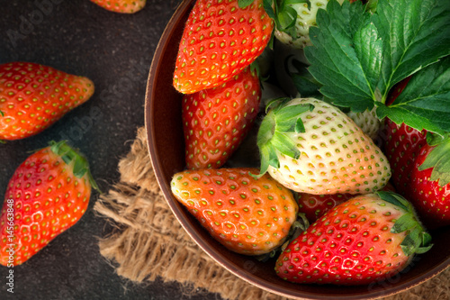  Top view of Red Strawberries and leaf with black stone background
