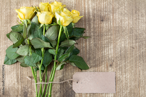 Bunch of yellow roses with blank tag