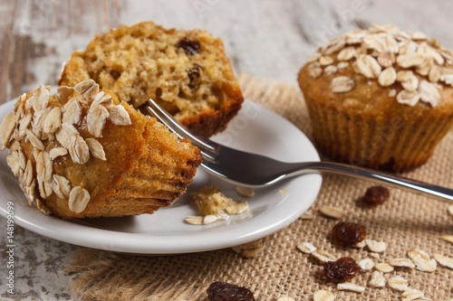 Poster Fresh muffins with oatmeal baked with wholemeal flour on white plate, delicious