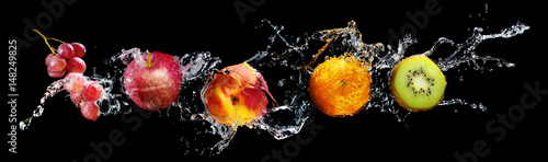 Fototapeta Set of fresh fruits in water splash isolated on black background