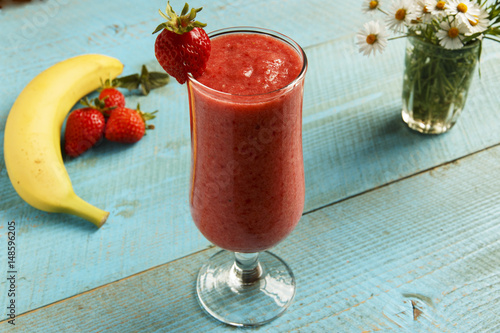 Strawberry banana smoothie in a glass on a table