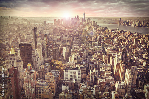 Fototapeta New York city skyline, sunrise in background.