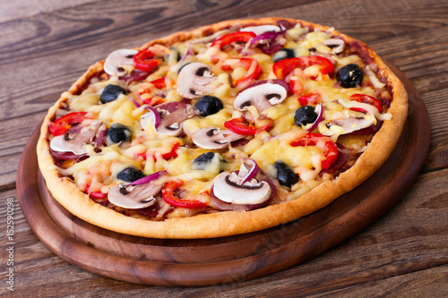 Pizza with seafood on wood table