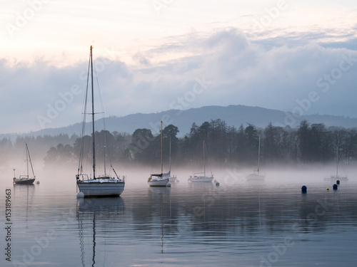  Sailing boats on misty lake