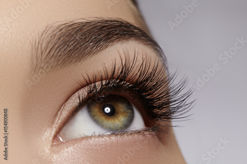 Beautiful female eye with extreme long eyelashes, black liner makeup. Perfect make-up, long lashes. Closeup fashion eyes © marinafrost