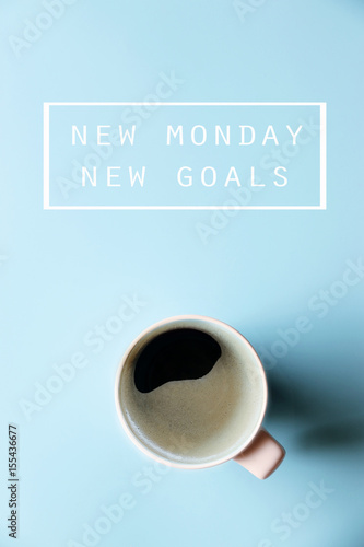NEW MONDAY NEW GOALS Concept and Morning coffee on blue background