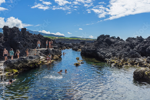 People swimming and enjoying summer in natural lava swimming pools ...