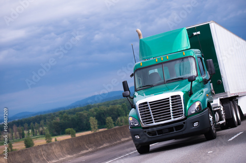 Green Semi Truck With Container Trailer On Highway Photos Ap Green Semi Truck With Container Trailer On Highway