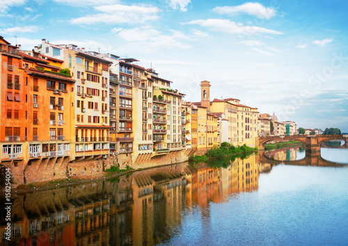 Poster old town houses reflecting in river Arno waters at summer day, Florence, Italy,
