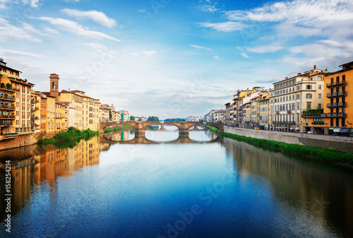 Poster old town with bridge Santa trinita reflecting in water of river Arno, Florence,
