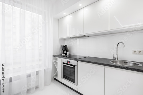 Lacobel White kitchen with black countertop
