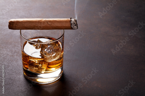 Whiskey with ice and cigar