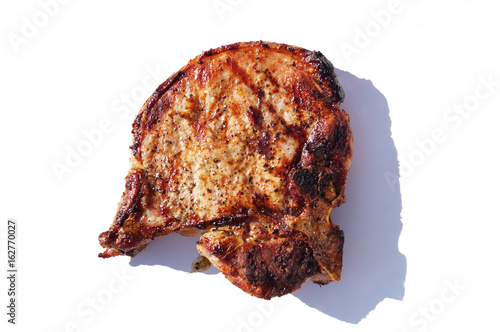 Colorful close up photo of  isolated delicious peace of steak meat cooked on grill fire on white background © Iryna