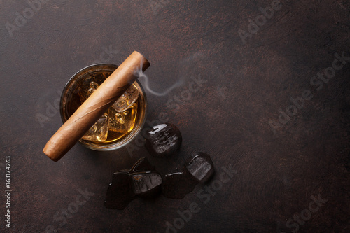Whiskey with ice and cigar