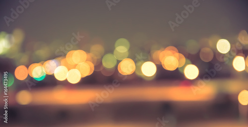 Defocused blur of city lights at night abstract with vintage tone