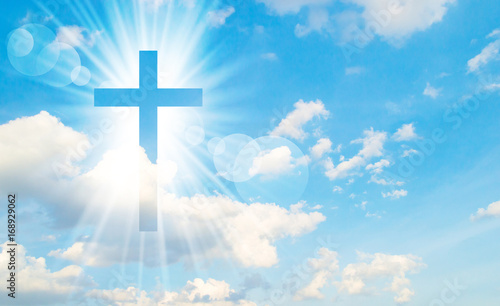 Obraz Fotograficzny Christian cross appears bright in the sky background