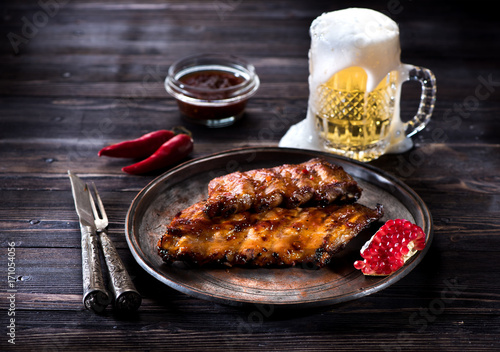 Obraz na płótnie Grilled pork baby ribs with barbecue sauce  and a mug beer