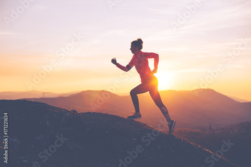 athletic-girl-finishes-a-run-in-the-mountains-at-sunset-sport-tight-clothes-intentional-motion-blur