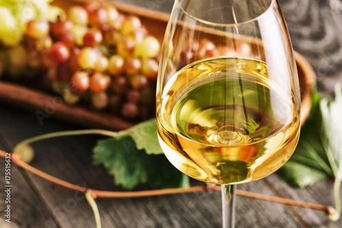 Glass of white wine on vintage wooden table
