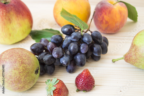 Fruit of the fall of autumn. apples, pears, blue grapes, peaches and juicе.background. fruit with green leaf